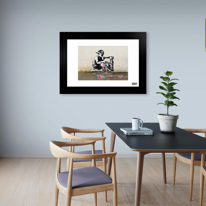 Bunting Boy, a framed print of Banksy's Graffiti-Homekor, Mounted in a dining room