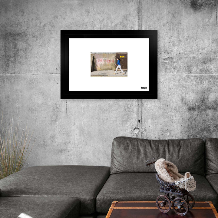 Eat the Rich, a framed print of Banksy's Graffiti-Homekor Mounted in a cozy room