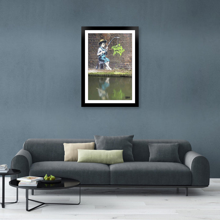 Fishing Boy, a framed print of Banksy's Graffiti-Homekor Mounted in a cozy room