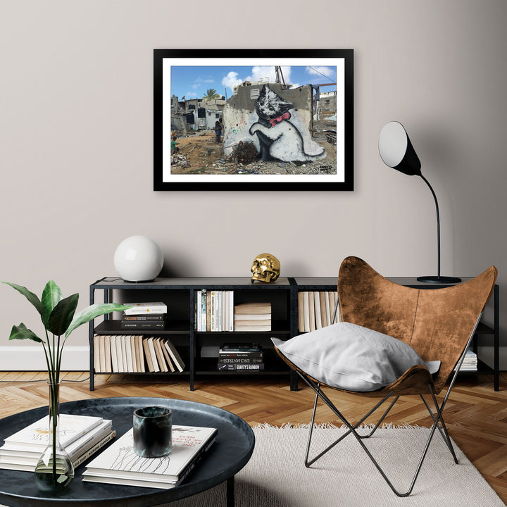 Gaza Kitten, a framed print of Banksy's Graffiti-Homekor Mounted in a cozy room