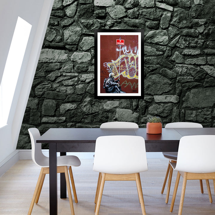 No Trespassing, a framed print of Banksy's Graffiti-Homekor Mounted in an office room