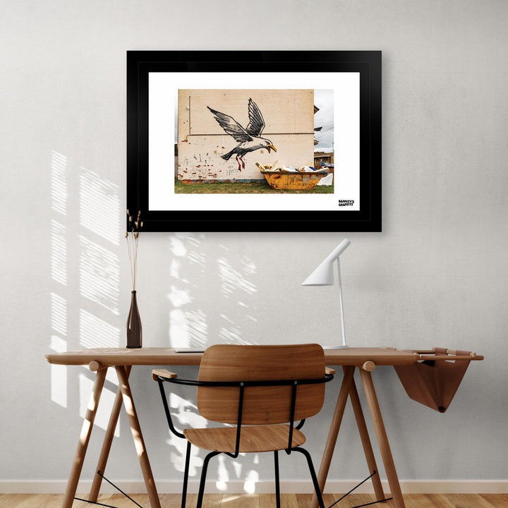 Seagul Raiding a Dumpster, a framed print of Banksy's Graffiti-Homekor Mounted in a home studio