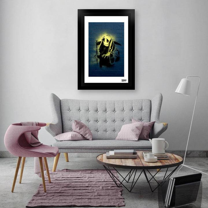 The Grin Reaper, a framed print of Banksy's Graffiti-Homekor Mounted in a cozy room