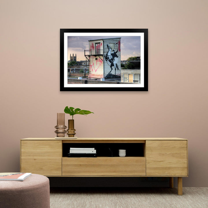 The Highway Man, a framed print of Banksy's Graffiti-Homekor Mounted in a cozy room