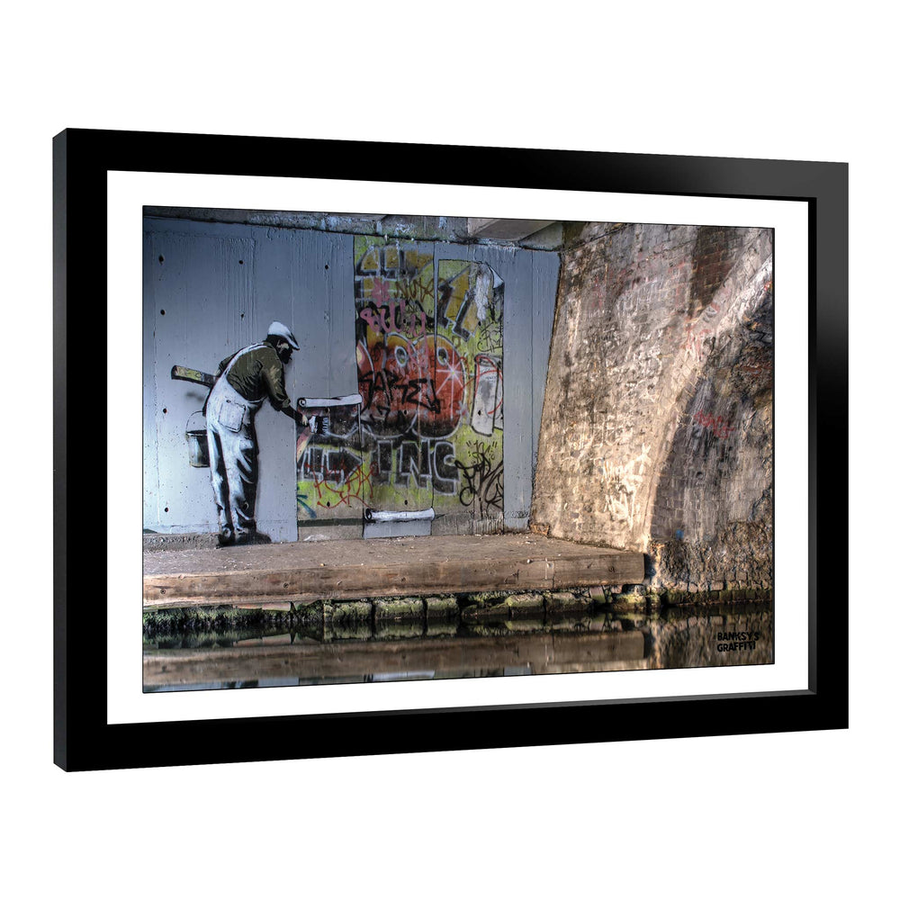 WallPaper man, a framed print of Banksy's Graffiti-Homekor