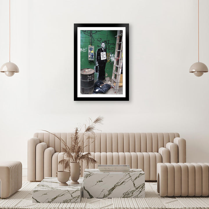 Work for Idiots, a framed print of Banksy's Graffiti-Homekor Mounted in a cozy room