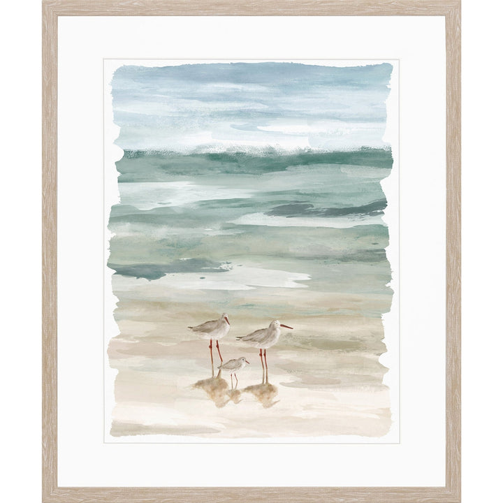 Watercolor painting framed art of beach with seashore birds walking along sand.